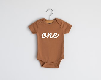 One Script First Birthday Organic Baby Bodysuit • Modern Baby Outfit • Unique Hand-Printed Modern Birthday Bodysuit in Camel Brown