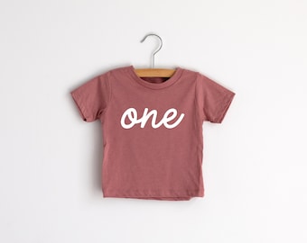 One First Birthday Kids T-Shirt • Modern Script Typographic Tee for Trendy Little One Year Olds • Mauve Pink Modern Birthday Shirt