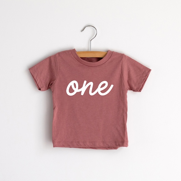 One First Birthday Kids T-Shirt • Modern Script Typographic Tee for Trendy Little One Year Olds • Mauve Pink Modern Birthday Shirt