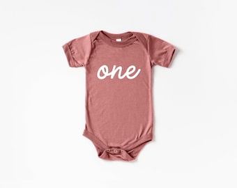 One Script First Birthday Outfit • Modern Typography Baby Bodysuit • Mauve Pink Birthday Bodysuit for Trendy Tots Turning One