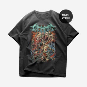 May include: A charcoal gray short-sleeve t-shirt featuring a graphic print of a skeletal figure and abstract organic shapes in shades of red, blue, and white. The text "ARCHSPIRE" appears in a stylized font above the graphic, with "MOSH PIT APPARELS" in a black circle.