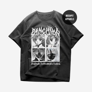 May include: A charcoal gray short-sleeve t-shirt featuring a white graphic print. The design includes the text PANCHIKO at the top, four anime-style character portraits in a grid, and the text D>E>A>T>H>M>E>T>A>L at the bottom.