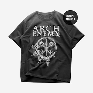 May include: A black short-sleeve t-shirt featuring the white text ARCH ENEMY above a circular graphic of skulls and a sword. A small black circular logo in the top right corner contains the white text MOSHPIT APPARELS in a sans-serif font.