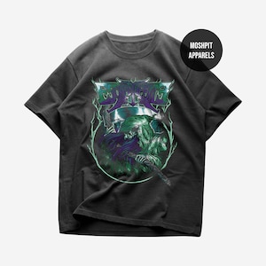 May include: A charcoal gray short-sleeve t-shirt featuring a graphic print of a hooded skeletal figure holding a scythe. The design includes purple and green accents with lightning-like details and the text MOSHPIT APPARELS in a black circle.