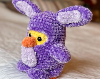 Crocheted chick with Easter bunny costume: amigurumi duckling and purple rabbit suit