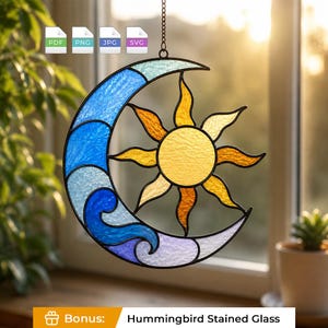 May include: A stained glass suncatcher featuring a crescent moon and a sun. The moon is composed of textured blue and light blue glass segments. The sun has a yellow center with orange and yellow rays. The piece hangs from a metal chain.