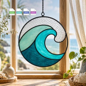 May include: A circular stained glass suncatcher featuring a stylized ocean wave design in shades of light green, bright turquoise, and deep blue, with a textured clear glass top section, all encased in a black metal frame and hanging by a chain.