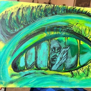 May include: A rectangular canvas painting featuring a large, stylized human eye rendered in vibrant shades of neon green and yellow. The iris contains vertical black bars resembling a cage, with a small, grey, humanoid figure visible inside.