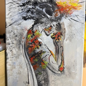 May include: An abstract painting on canvas depicting a figure with a head of dark, textured black paint. The body is rendered in shades of gray with vibrant patches of red, orange, and yellow paint, creating a stark contrast against the light gray background.