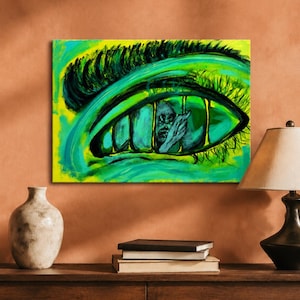 May include: A rectangular canvas painting featuring a large, stylized human eye in vibrant shades of neon green and yellow. The iris contains a dark, detailed illustration of a person behind vertical bars, with thick black eyelashes above.