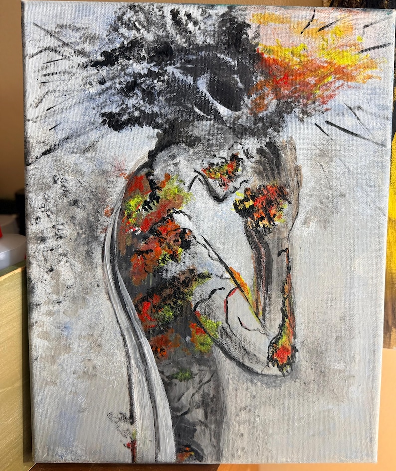 May include: An abstract painting on canvas depicting a figure with a head of dark, textured black paint. The body is rendered in shades of gray with vibrant patches of red, orange, and yellow paint, creating a stark contrast against the light gray background.