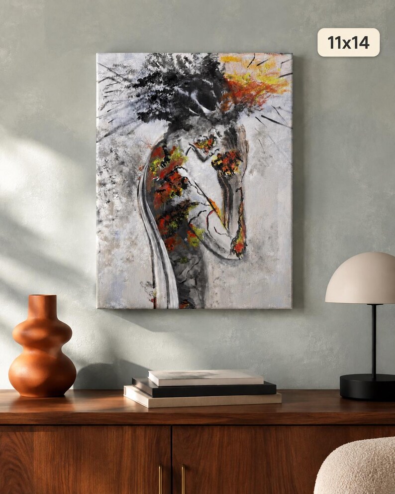 May include: A rectangular canvas wall art piece measuring 11x14 inches, featuring an abstract painting of a figure in profile. The artwork uses a palette of black, white, gray, and vibrant orange and yellow accents to depict a textured, expressive form.
