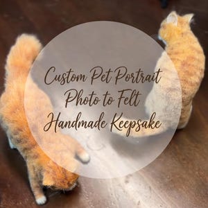 May include: Two orange tabby cat figurines made of felt, positioned on a dark wooden surface. The text Custom Pet Portrait Photo to Felt Handmade Keepsake is overlaid in the centre of the image in a dark brown cursive script font.