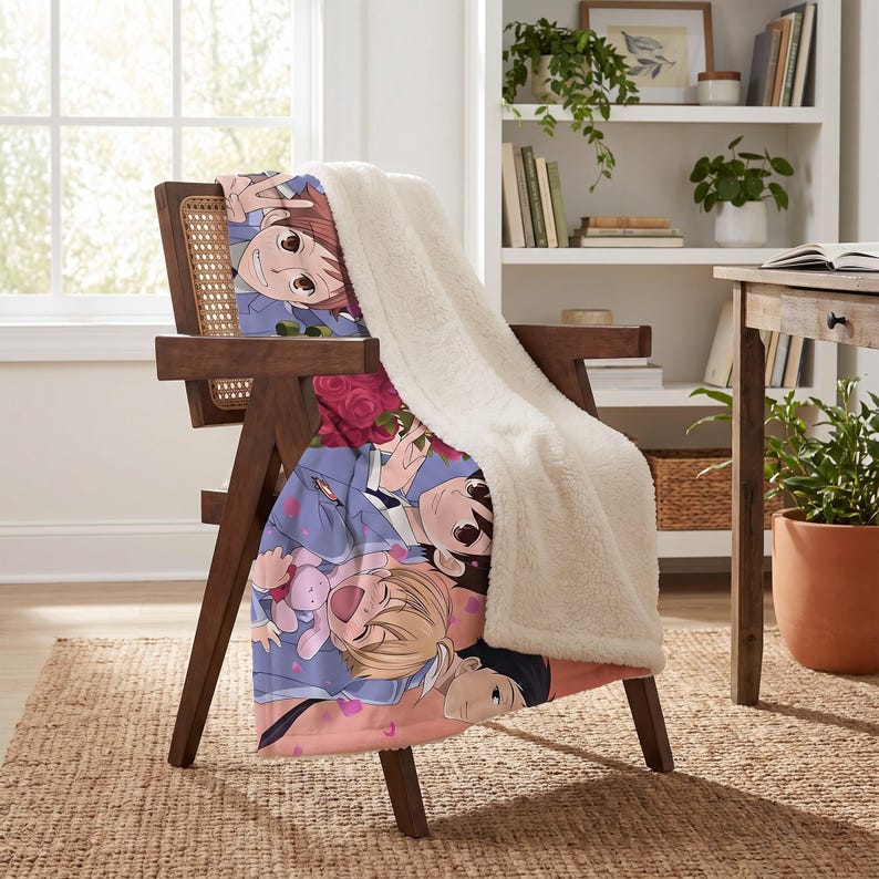 May include: A plush throw blanket featuring a colorful anime-style illustration of four characters with brown, blonde, and black hair, accented by red roses and pink petals, with a thick, white, textured sherpa fleece lining on the reverse side.
