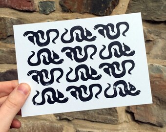 Winged Snake Pattern Postcard, block print repeat pattern, illustration of winged snakes in a repeat pattern, black and white illustration