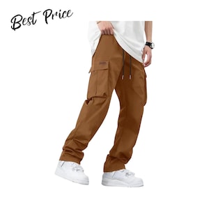 May include: Brown cargo pants featuring a drawstring waist, large side pockets with flaps, and a straight-leg fit. The pants are paired with a white t-shirt and white sneakers. The text "Best Price" is visible in the upper left corner.