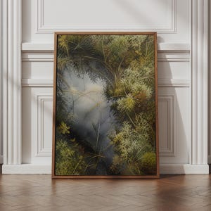 May include: A rectangular wall art piece in a wooden frame featuring a detailed painting of a forest floor. The artwork displays various shades of green moss, lichen, and thin blades of grass surrounding a dark, reflective pool of water.
