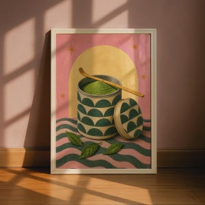 May include: A framed wall art print featuring a cylindrical container filled with green matcha powder, decorated with a dark green semi-circle pattern. A wooden scoop rests across the top, with three green tea leaves and a matching lid nearby.