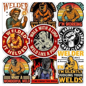 May include: A collection of nine circular and shaped vinyl stickers featuring welding themes. Designs include a skull welder, a hand holding a wrench, and various welders in helmets with text such as 'Welder', 'I Welded It Helded', and 'I'm Silently Judging Your Welds'.
