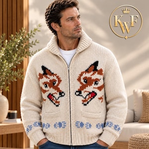 May include: A cream-colored knit zip-up cardigan featuring a shawl collar and two front pockets. The garment displays two large fox head motifs in orange, black, and white, with a blue floral pattern along the ribbed hem and sleeve cuffs.