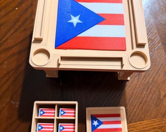 May include: A beige 3D-printed square table featuring a Puerto Rican flag design on its surface. Below the table are a small beige four-compartment storage tray containing four miniature Puerto Rican flags and one separate rectangular beige tile.