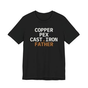 May include: A black short-sleeve t-shirt featuring white text that reads COPPER PEX CAST IRON and the word FATHER in orange text below it. The shirt has a crew neckline and a standard fit, displaying the printed text clearly on the front chest area.