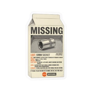 May include: A die-cut sticker shaped like a milk carton featuring a missing person poster design for a 10mm socket. The graphic includes the text MISSING, LOST: 10MM SOCKET, and various humorous details about the tool's age, weight, and last seen location.