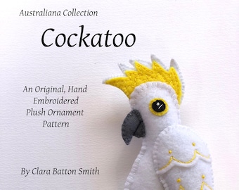 May include: A white plush cockatoo ornament with yellow and gray accents, part of the Australiana Collection. The bird is hand-embroidered and features a yellow crest, tail, and wing details. Text on the image reads "Cockatoo" and "An Original, Hand Embroidered Plush Ornament Pattern."