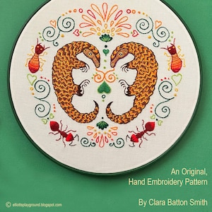 May include: A hand-embroidered hoop art piece featuring two pangolins, red ants, and a floral design. The hoop is green and the embroidery is on white fabric. The text "Pangolins" is at the top of the image and "An Original, Hand Embroidery Pattern By Clara Batton Smith" is at the bottom.