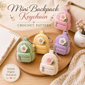 May include: Five miniature crochet backpack keychains in pastel pink, yellow, purple, green, and cream, each featuring a small flower appliqué and a silver zipper. The text reads Mini Backpack Keychain CROCHET PATTERN and Instant Digital Download.
