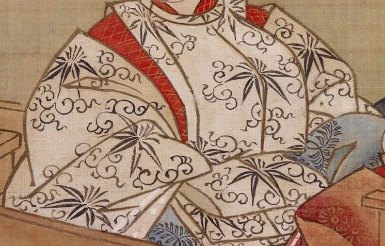 May include: A detail of a traditional Japanese painting. The subject wears a cream-colored garment with a repeating pattern of black stylized leaves and swirling designs. Red accents and trim are visible.