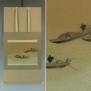 May include: A Japanese scroll painting depicting boats on water. The artwork features a muted color palette with tan, gold, and gray tones. The scroll is mounted with tan fabric and decorative accents. The painting style is traditional.