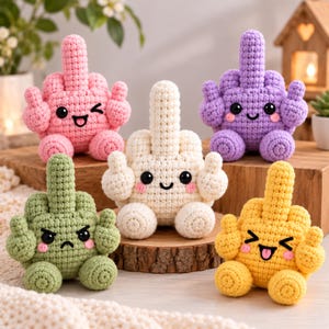 May include: Five small, crocheted plush figures in pink, cream, purple, olive green, and yellow. Each figure features a central raised middle finger, two side arms, and two legs, with embroidered facial expressions including eyes and mouths.