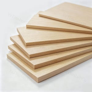 May include: A stack of six rectangular light-coloured wooden boards with a smooth, natural grain finish. Each board is layered in a staggered formation. The text YzTimberCo is faintly visible on the surface of the wooden boards in the image.