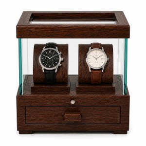 May include: A dark brown wooden watch display case with a glass top and sides, featuring two curved watch holders inside. One holder displays a silver watch with a black face and strap, while the other holds a silver watch with a white face and brown strap.