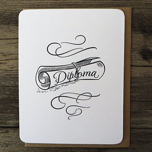 May include: A white card with a black and white illustration of a rolled up diploma with the word "Diploma" written on it. The illustration is surrounded by decorative flourishes.