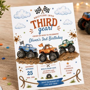 May include: A rectangular birthday invitation card featuring a monster truck theme with the text Shifting into Third Gear, Oliver's 3rd Birthday, and event details. The design includes illustrations of three colorful monster trucks on dirt mounds, checkered flags, clouds, and stars in blue, orange, and brown tones.