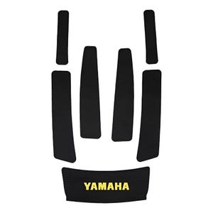 May include: A set of six black adhesive protective pads with a textured surface. Four pads are long and narrow, two are shorter, and one wider bottom pad features the yellow text YAMAHA printed in a bold, sans-serif font centered on the surface.