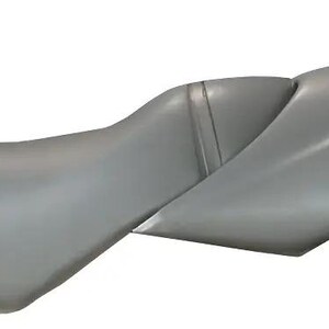 May include: A gray motorcycle seat with a contoured, ergonomic shape and a smooth finish. The word BOMBARDIER is printed in black capital letters on the side of the rear section. The seat features a distinct seam separating the front and back.
