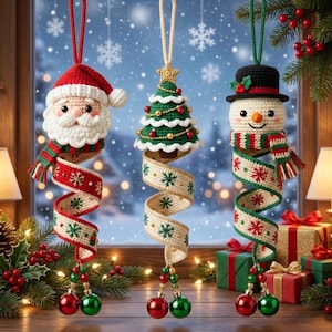 May include: Three crochet Christmas ornaments featuring a Santa Claus, a decorated pine tree, and a snowman. Each figure hangs from a spiral ribbon embroidered with red and green snowflakes, finished with two dangling red and green baubles.