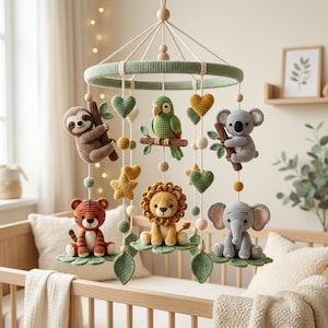 May include: A nursery mobile featuring crocheted animal figures including a sloth, parrot, koala, tiger, lion, and elephant. The figures are suspended from a sage green circular frame with crocheted hearts, stars, and leaves in various colors.