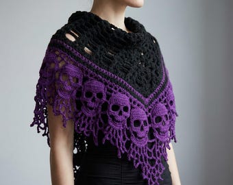 May include: A crochet shawl featuring a black upper section with a textured pattern and a vibrant purple lower section adorned with a repeating skull motif. The edges of the shawl are finished with an intricate, openwork fringe design.