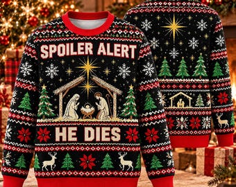 May include: A black long-sleeve knit sweater featuring a red crew neck, cuffs, and hem. The front displays a nativity scene with a star, Christmas trees, snowflakes, and reindeer, with the white text SPOILER ALERT HE DIES.