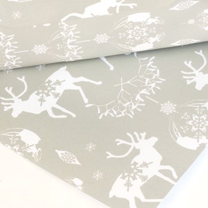 May include: Gray wrapping paper with a white reindeer and snowflake pattern.