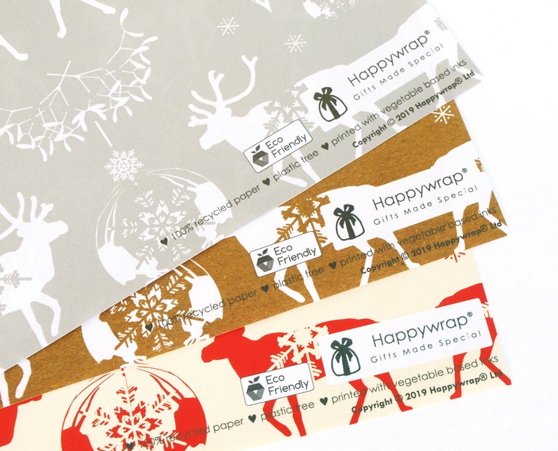 May include: Three rolls of brown and white patterned wrapping paper with reindeer and snowflake designs. The paper is made from recycled paper and is printed with vegetable-based inks. The paper is labeled "Happywrap Gifts Made Special" and "Eco Friendly".