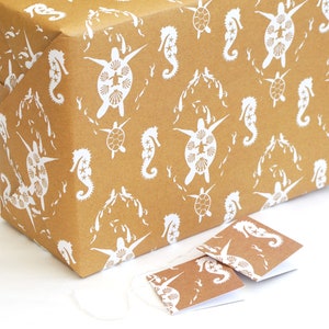 May include: Brown wrapping paper with a white seahorse and turtle pattern. Two small gift tags with the same pattern are included.