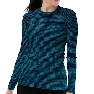 May include: A long-sleeved shirt with a dark blue background and a pattern of small green dots. The shirt has a crew neck and a fitted silhouette.