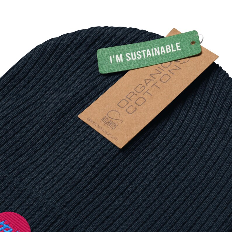 Classic ribbed beanie. Synthwave in retro front in bright blue with hot pink shadow over a sunset in hot pink.
6 colours available.
Oxford Navy
Black
Light Avio Blue
Light Grey
Leaf Green
Mustard Yellow.
Organic cotton sustainable tags shown.