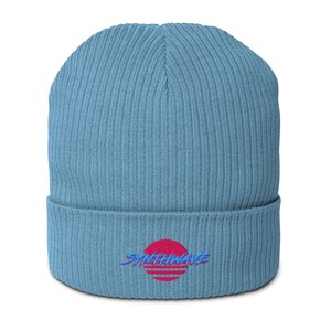 Classic ribbed beanie. Synthwave embroidered in retro front in bright blue with hot pink shadow over a sunset in hot pink.
6 colours available.
Oxford Navy
Black
Light Avio Blue
Light Grey
Leaf Green
Mustard Yellow.
Light Avio Blue shown.