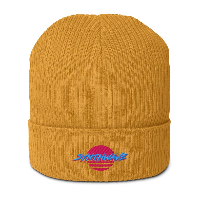 Classic ribbed beanie. Synthwave in retro front in bright blue with hot pink shadow over a sunset in hot pink.
6 colours available.
Oxford Navy
Black
Light Avio Blue
Light Grey
Leaf Green
Mustard Yellow.
Mustard yellow shown.